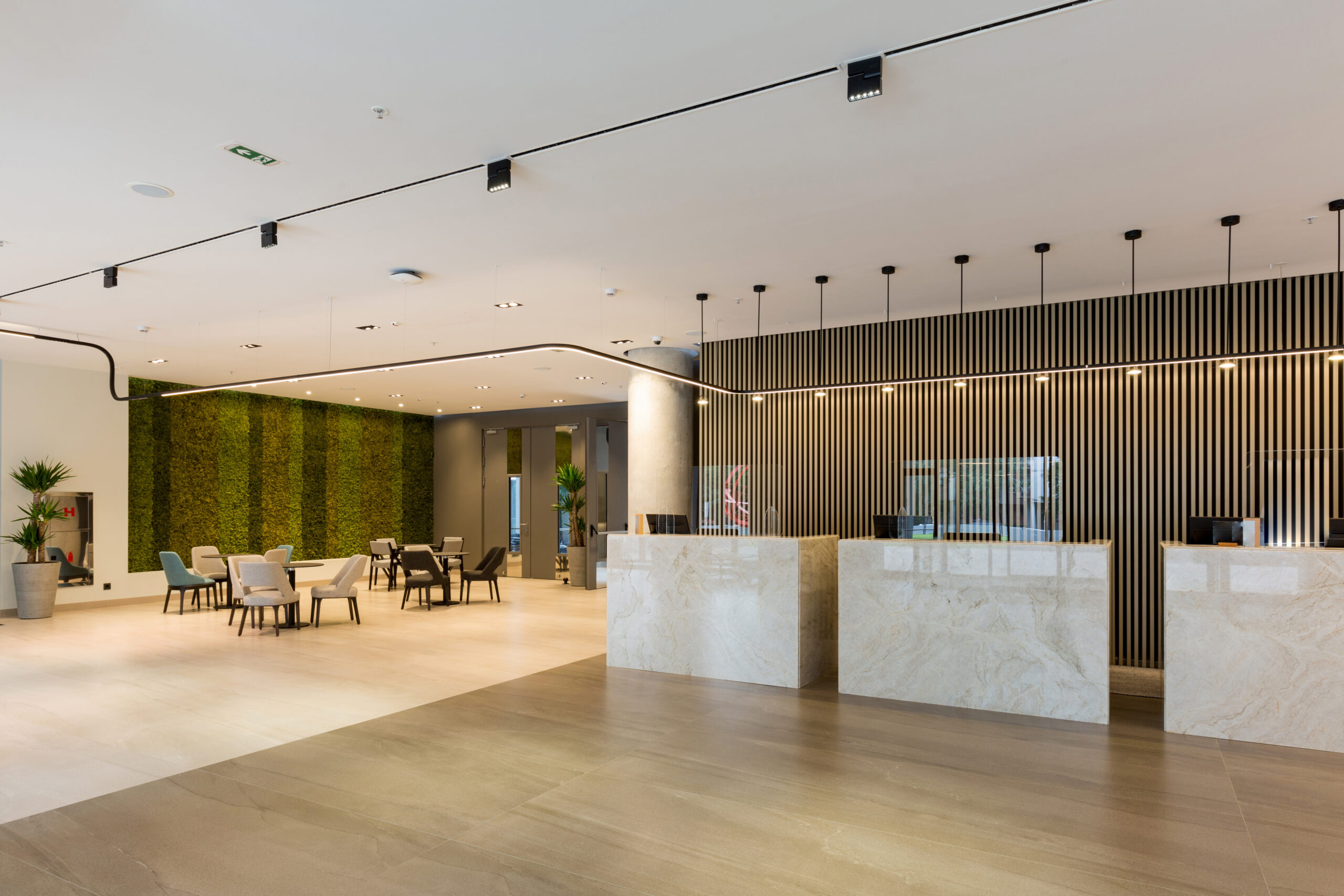 Interior of a hotel lobby with reception desks with transparent